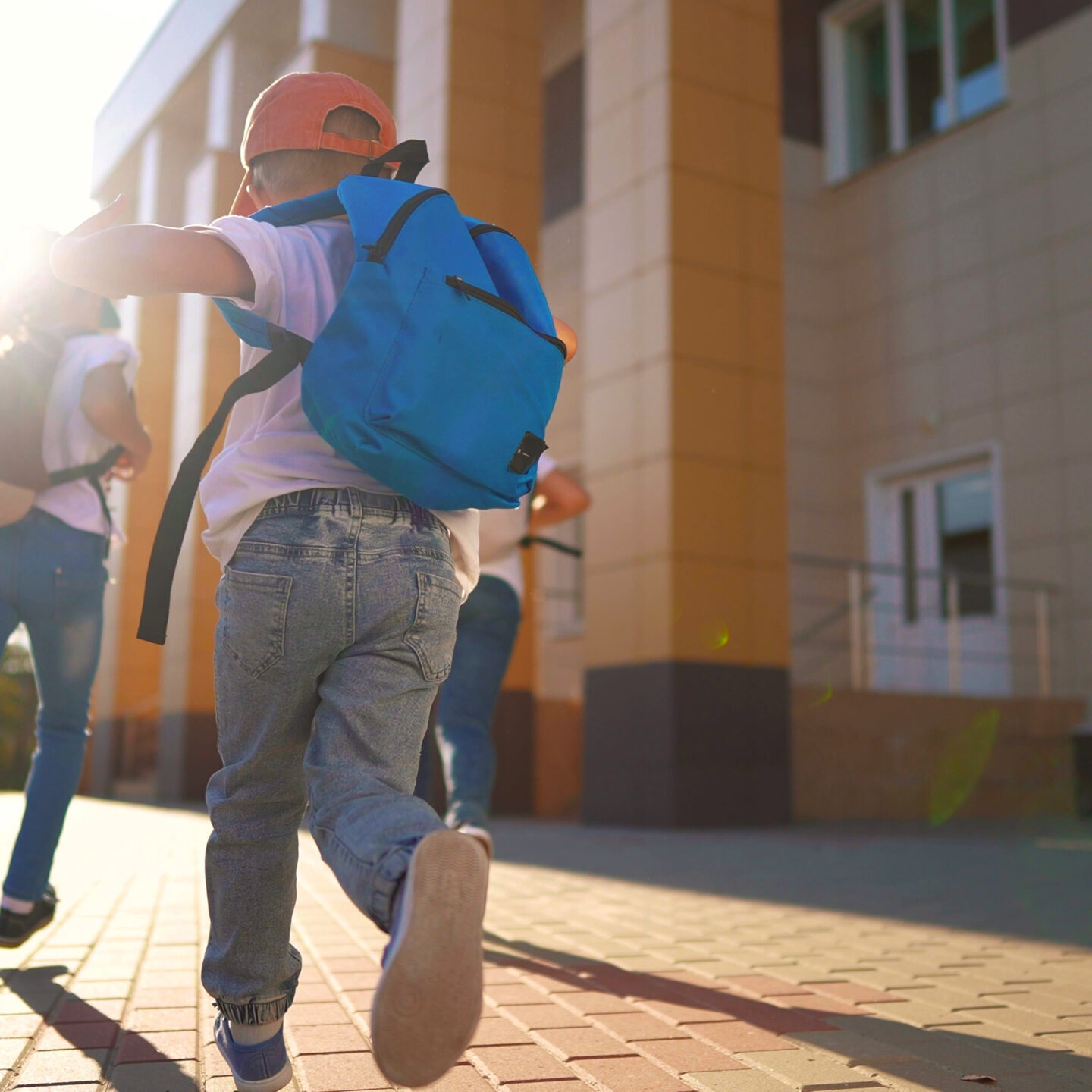 A group of kids running back to school. Bag elementary happy concept. Children running around in a backpack lifestyle at. school. A group of children running back to school with their backpacks.